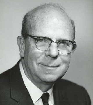 black and white photo of William Everitt as a middle aged man with glasses wearing a suit.
